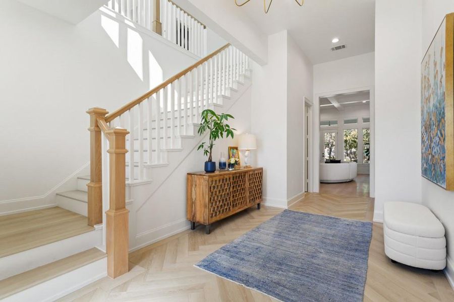 Entrance foyer featuring stairway and baseboards