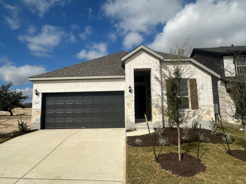Front exterior of a new home in La Cima, San Marcos, TX, highlighting curb appeal (Image 1).