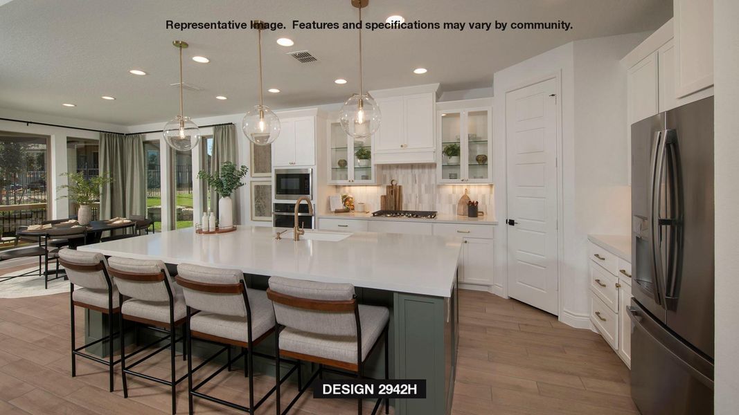 Kitchen featuring appliances with stainless steel finishes, wood finished floors, recessed lighting, light countertops, and white cabinets Kitchen featuring appliances with stainless steel finishes, wood finished floors, recessed lighting, light countertops, and white cabinets