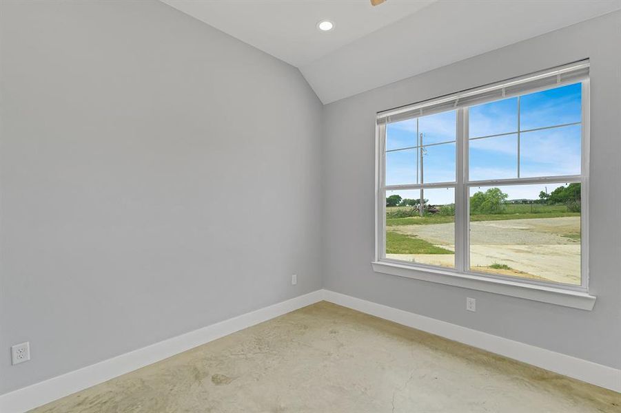Spare room with concrete floors, baseboards, lofted ceiling, recessed lighting, and ceiling fan