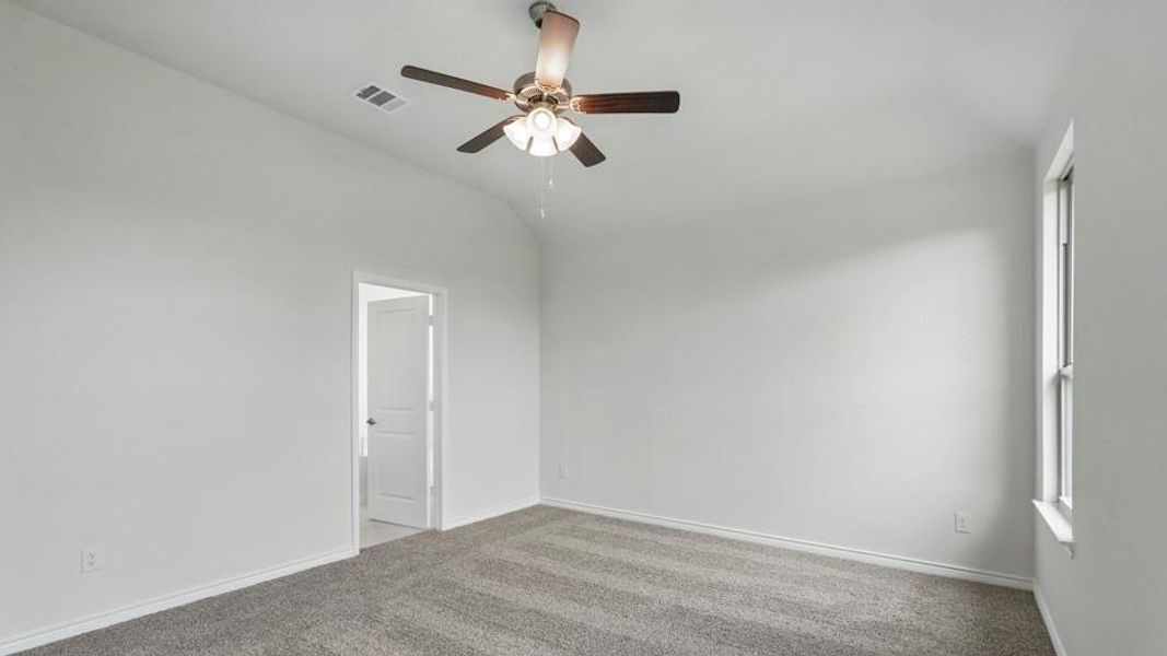 Unfurnished room featuring vaulted ceiling, carpet floors, and ceiling fan