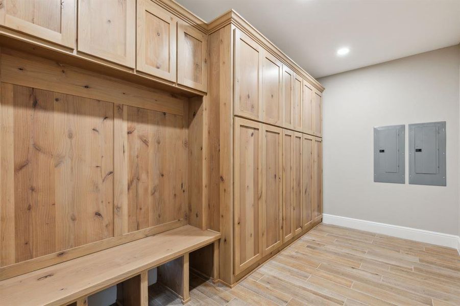 Mudroom with recessed lighting, baseboards, electric panel, plenty of cabinet space and wood look tile flooring Mudroom with recessed lighting, baseboards, electric panel, plenty of cabinet space and wood look tile flooring