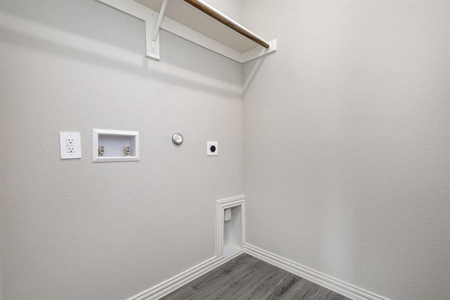 Clothes washing area with hookup for an electric dryer, gas dryer hookup, dark wood-type flooring, and hookup for a washing machine