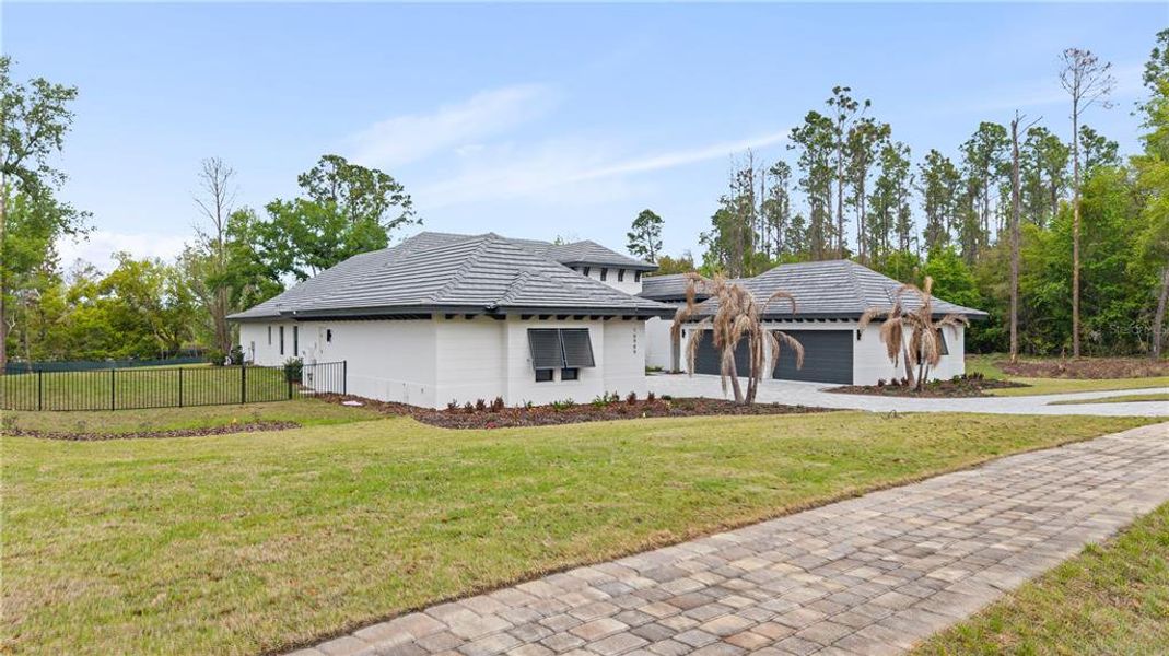 Front exterior of a new home in Bella Collina, Montverde, FL, highlighting curb appeal (Image 20). Front exterior of a new home in Bella Collina, Montverde, FL, highlighting curb appeal (Image 20).