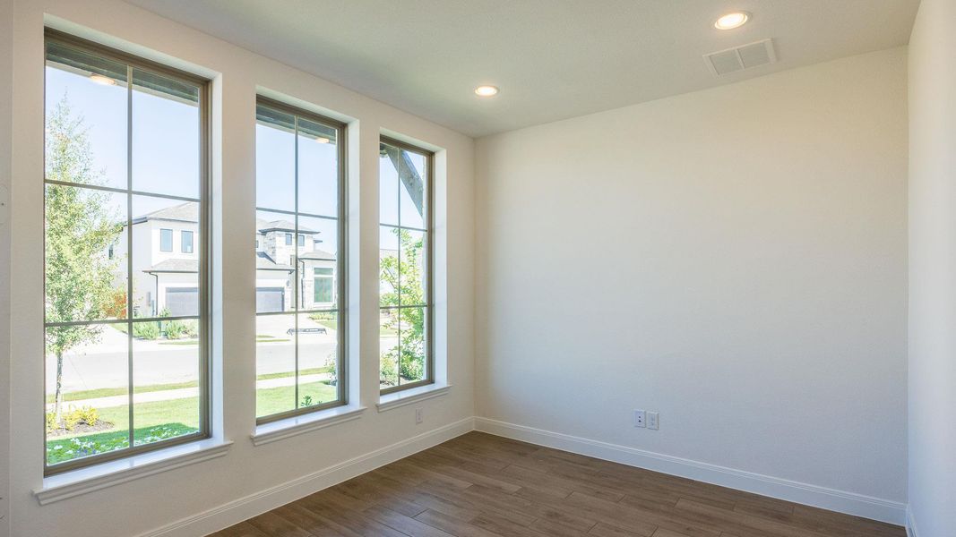 Empty room with dark wood-style flooring and recessed lighting Empty room with dark wood-style flooring and recessed lighting
