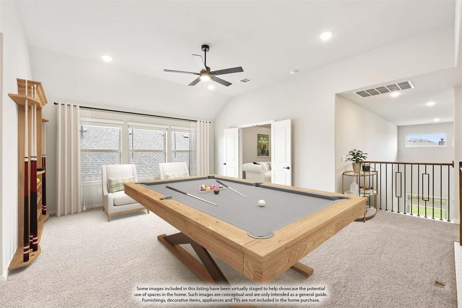 Game room with pool table, vaulted ceiling, ceiling fan, and open staircase railing on upper floor Game room with pool table, vaulted ceiling, ceiling fan, and open staircase railing on upper floor