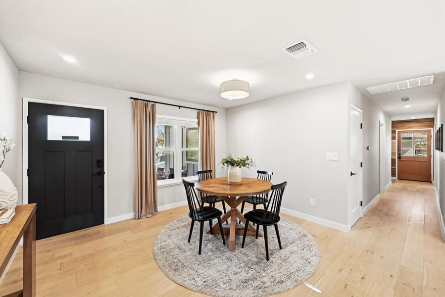 Dining space featuring light wood-style flooring and recessed lighting