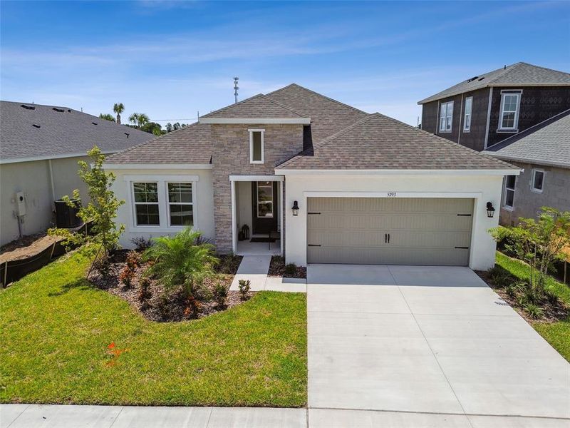 Front exterior of a new home in Waterset, Apollo Beach, FL, highlighting curb appeal (Image 22). Front exterior of a new home in Waterset, Apollo Beach, FL, highlighting curb appeal (Image 22).