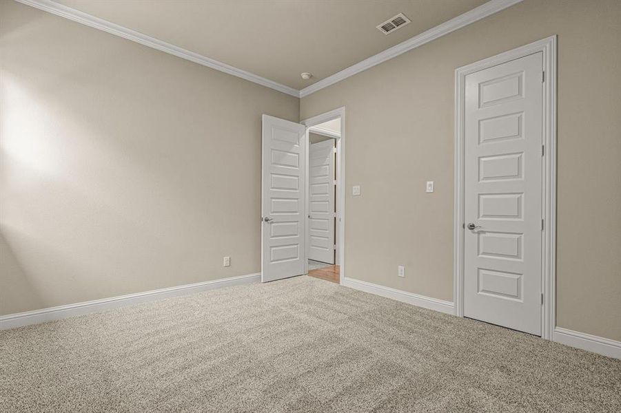 Unfurnished bedroom with carpet and crown molding