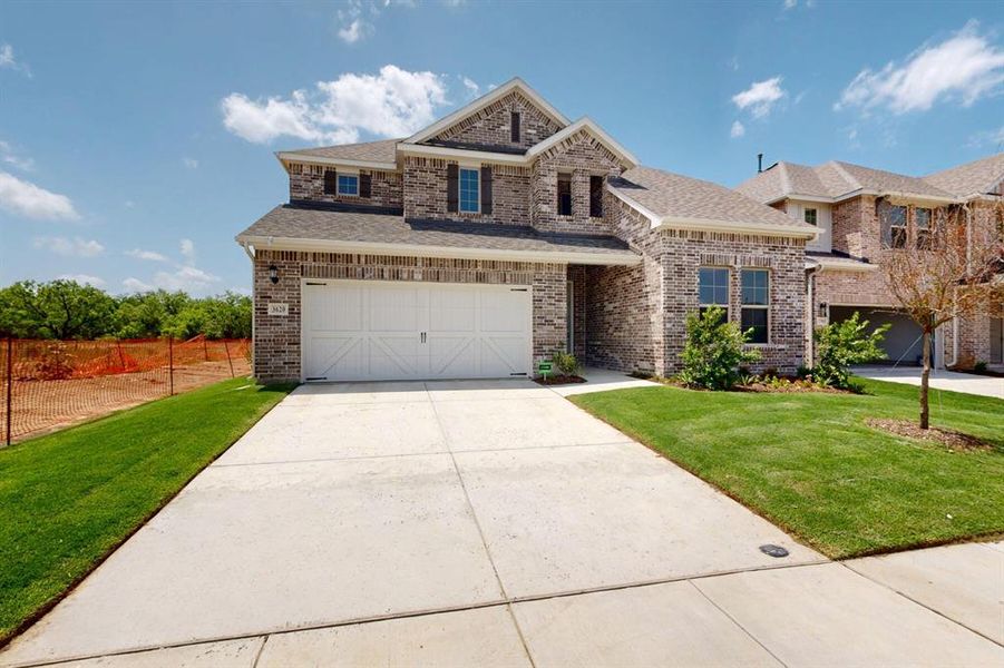 Front exterior of a new home in Lilybrooke at Legacy Hills, Celina, TX, highlighting curb appeal (Image 23).
