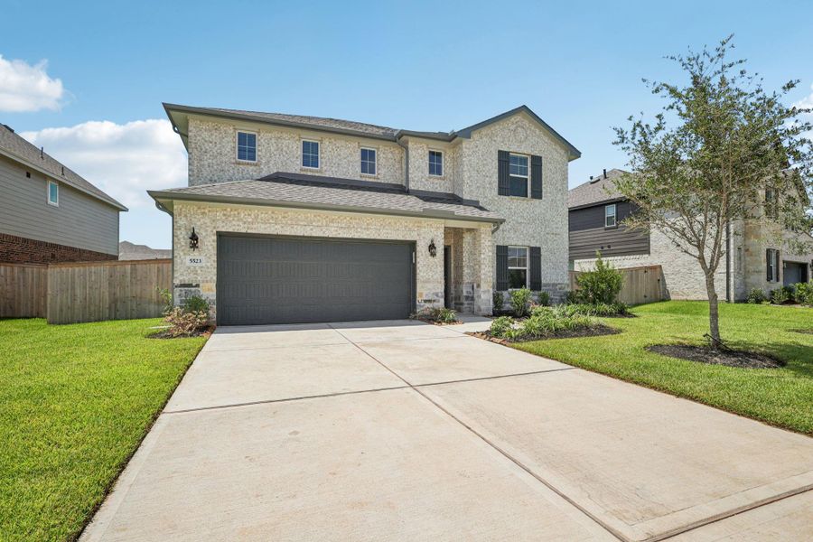Front exterior of a new home in Kingdom Heights, Rosenberg, TX, highlighting curb appeal (Image 27).