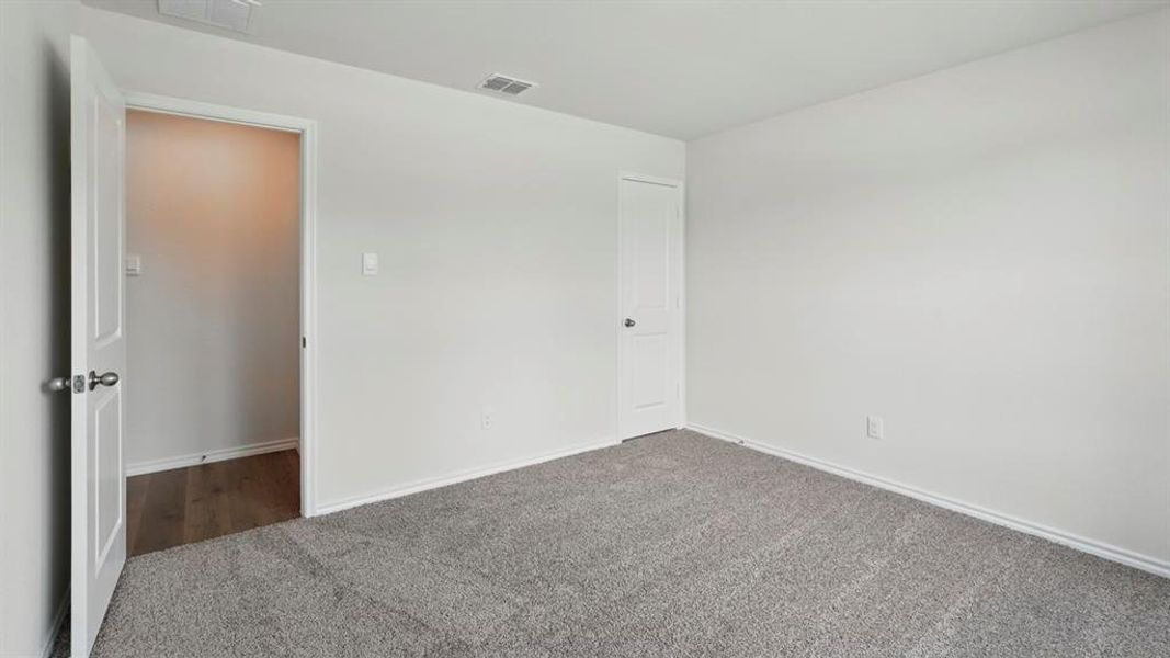 Unfurnished bedroom with carpet and baseboards