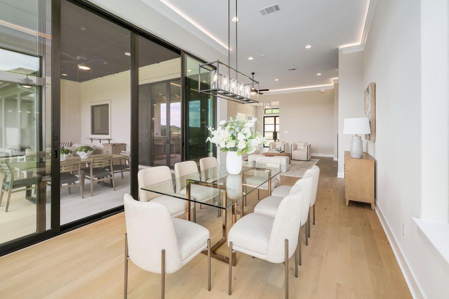 An open concept dining area features ample natural light and seamless indoor-outdoor living.