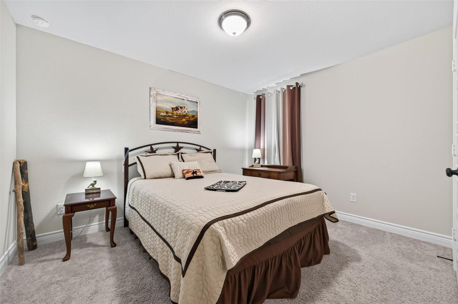 This spacious and well-lit secondary bedroom is conveniently situated at the front of the home, offering easy access. The room features ample space for a variety of furniture arrangements and is finished with tasteful details, making it an ideal setting. Could be a cozy home office, or a comfortable bedroom for family members. This spacious and well-lit secondary bedroom is conveniently situated at the front of the home, offering easy access. The room features ample space for a variety of furniture arrangements and is finished with tasteful details, making it an ideal setting. Could be a cozy home office, or a comfortable bedroom for family members.