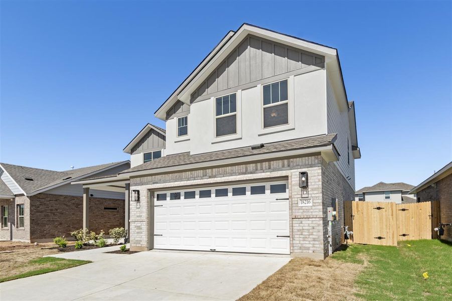 View of front of home featuring board and batten siding, fence, brick siding, a garage, and concrete driveway View of front of home featuring board and batten siding, fence, brick siding, a garage, and concrete driveway