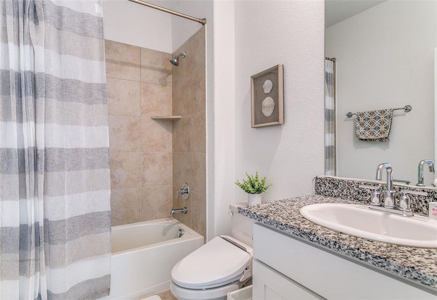 Full bath with shower / bath combo with shower curtain and vanity