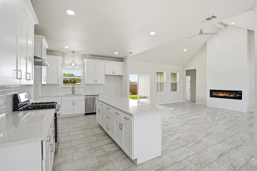 Open-concept living space featuring a contemporary kitchen and living area