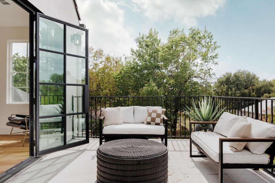 The primary suite balcony offers treetop views of Old Enfield and a tranquil escape from the day. The primary suite balcony offers treetop views of Old Enfield and a tranquil escape from the day.