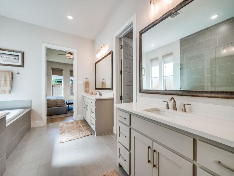 Full bathroom featuring a ceiling fan, two vanities, tile patterned floors, recessed lighting, and ensuite bath
