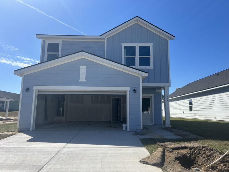 Front exterior of a new home in , Ravenel, SC, highlighting curb appeal (Image 1). Front exterior of a new home in , Ravenel, SC, highlighting curb appeal (Image 1).