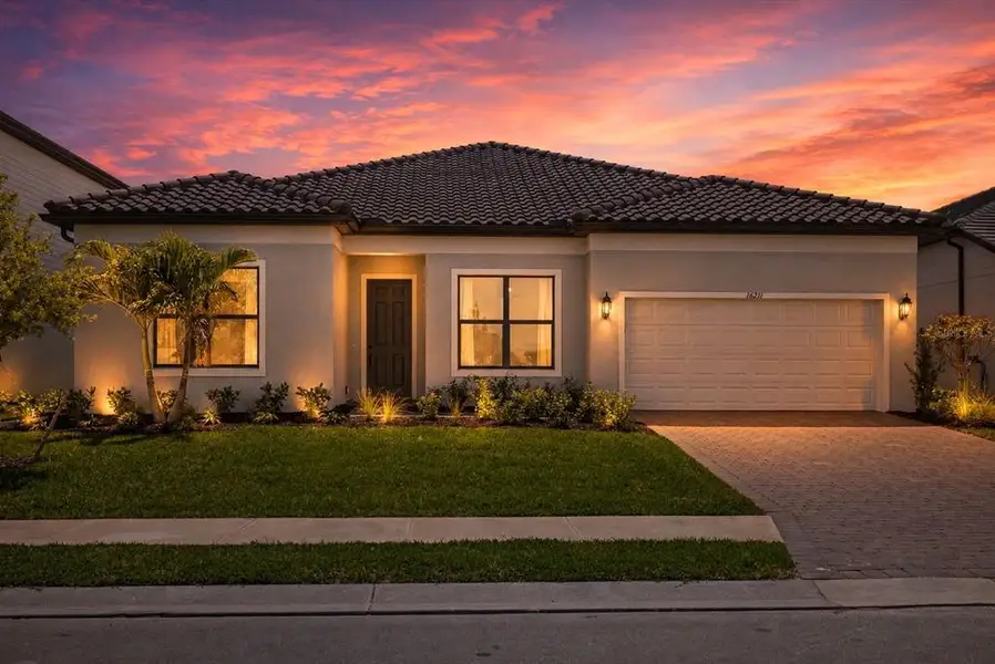 Front exterior of a new home in , Lakewood Ranch, FL, highlighting curb appeal (Image 1). Front exterior of a new home in , Lakewood Ranch, FL, highlighting curb appeal (Image 1).