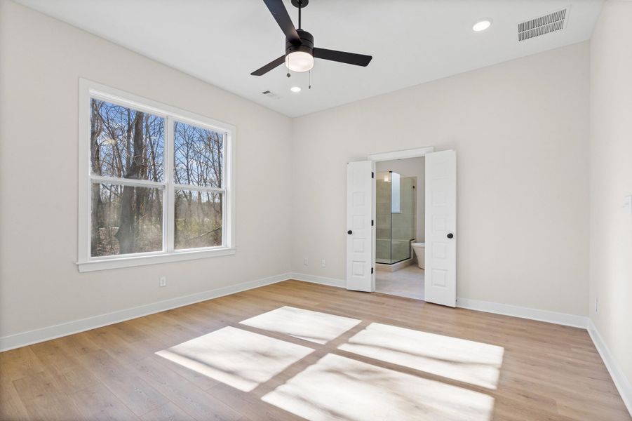 Unfurnished bedroom featuring light wood-style floors, ensuite bathroom, recessed lighting, and ceiling fan Unfurnished bedroom featuring light wood-style floors, ensuite bathroom, recessed lighting, and ceiling fan