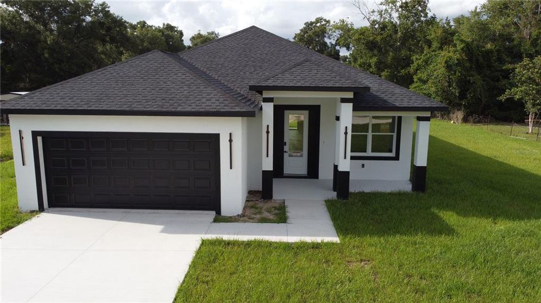 Front exterior of a new home in , Summerfield, FL, highlighting curb appeal (Image 27).