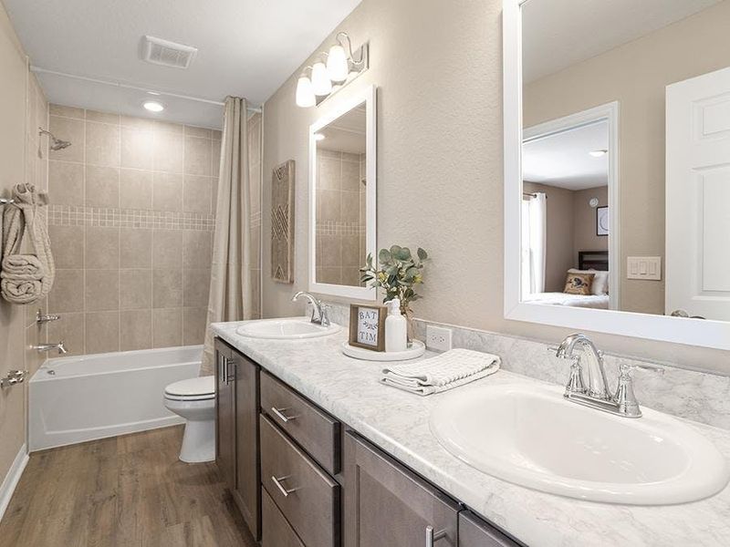 The secondary bedrooms share a Jack-and-Jill  bath - Isla townhome by Highland Homes