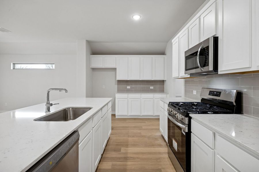 Kitchen in the Heisman home plan by Trophy Signature Homes – REPRESENTATIVE PHOTO