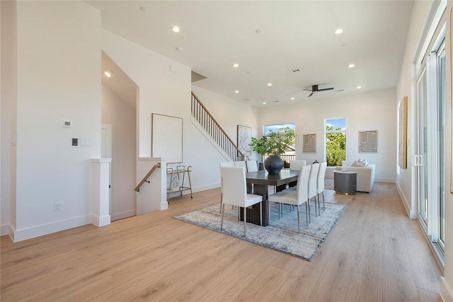 Dining room with recessed lighting, light wood-style flooring, stairs, and ceiling fan Dining room with recessed lighting, light wood-style flooring, stairs, and ceiling fan
