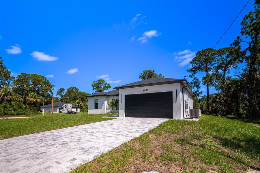 Front exterior of a new home in , Lehigh Acres, FL, highlighting curb appeal (Image 38). Front exterior of a new home in , Lehigh Acres, FL, highlighting curb appeal (Image 38).