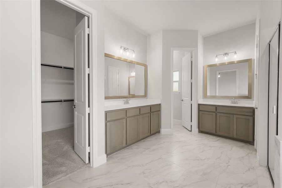 Full bathroom featuring two vanities, marble look tile flooring, and a spacious closet Full bathroom featuring two vanities, marble look tile flooring, and a spacious closet