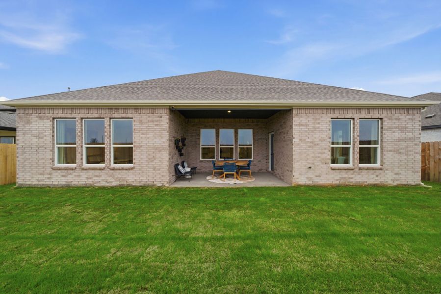 A house with a lawn and chairs. A house with a lawn and chairs.