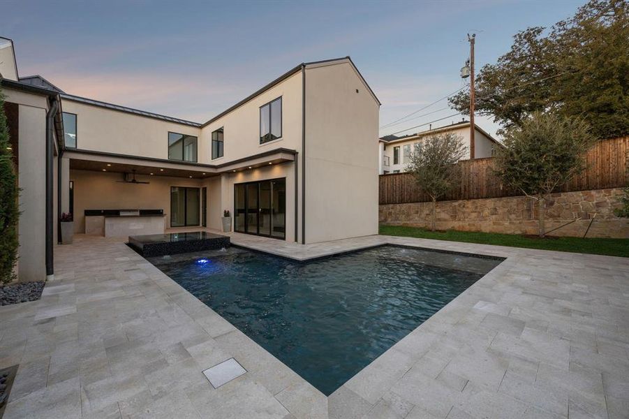 View of swimming pool with exterior kitchen, ceiling fan, a patio, and a pool with connected hot tub View of swimming pool with exterior kitchen, ceiling fan, a patio, and a pool with connected hot tub