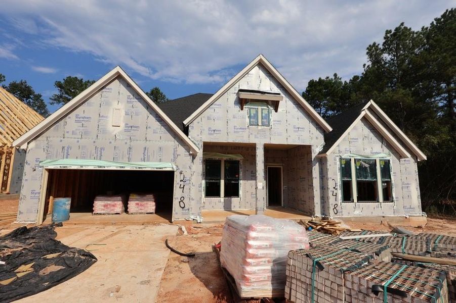 Front exterior of a new home in The Woodlands Hills 70’, Willis, TX, highlighting curb appeal (Image 1). Front exterior of a new home in The Woodlands Hills 70’, Willis, TX, highlighting curb appeal (Image 1).
