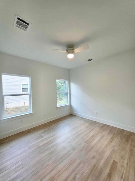 Unfurnished room featuring light wood-type flooring and baseboards