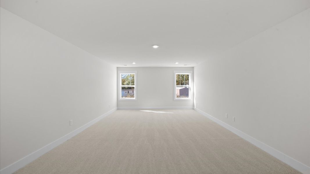 Elegant, carpeted bonus room that adds a superior layer of flexibility to the home’s design Elegant, carpeted bonus room that adds a superior layer of flexibility to the home’s design