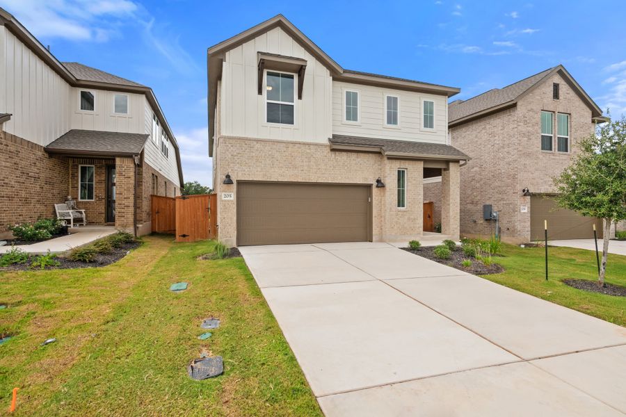 Front exterior of a new home in Lariat, Liberty Hill, TX, highlighting curb appeal (Image 27).