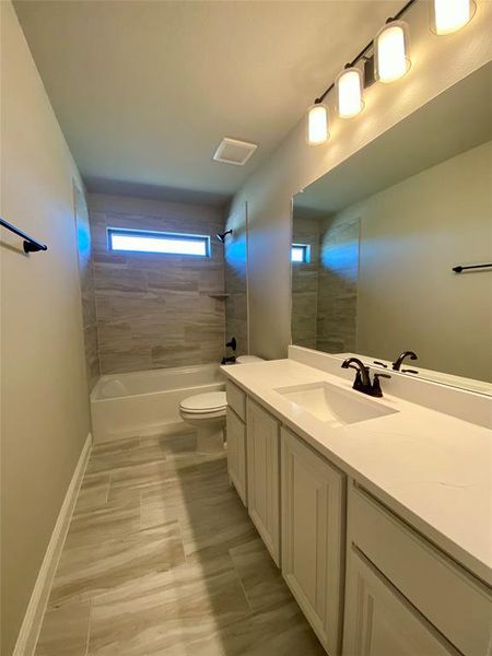 Bath 3 with window for natural light, quartz counters & 12x24 tile Bath 3 with window for natural light, quartz counters & 12x24 tile