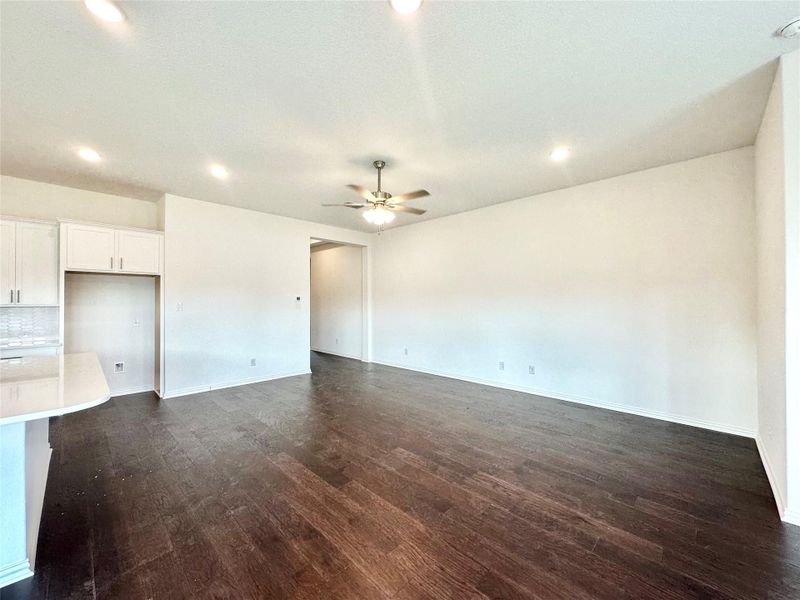 Unfurnished living room with dark wood-style flooring, recessed lighting, and ceiling fan Unfurnished living room with dark wood-style flooring, recessed lighting, and ceiling fan