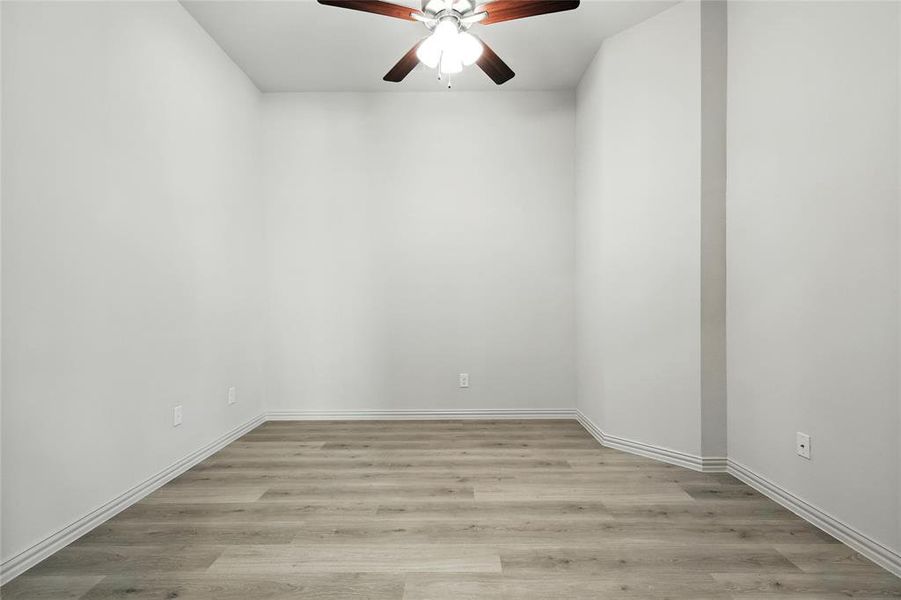 Unfurnished room featuring a ceiling fan and light wood-type flooring Unfurnished room featuring a ceiling fan and light wood-type flooring