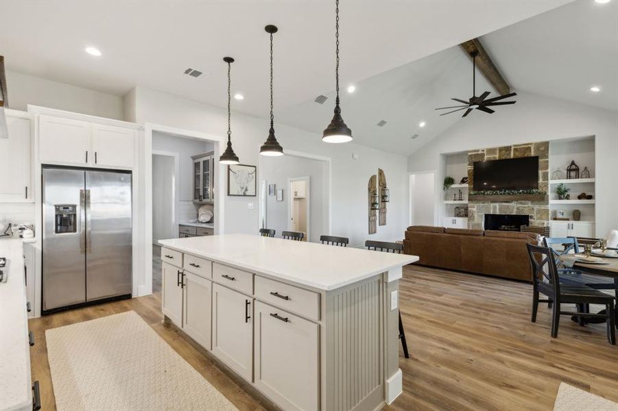 Kitchen island with white countertop and pendant lighting