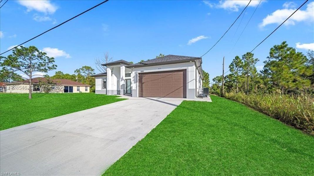 Front exterior of a new home in , Lehigh Acres, FL, highlighting curb appeal (Image 21).