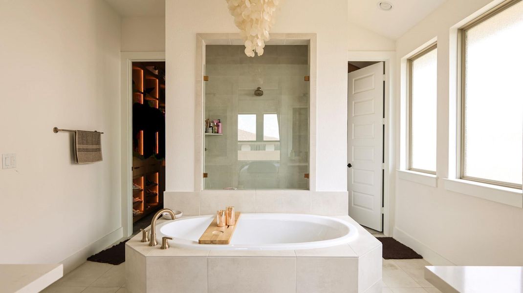 Indulge in a tranquil retreat featuring a soaking tub and a spacious glass-enclosed shower. Indulge in a tranquil retreat featuring a soaking tub and a spacious glass-enclosed shower.