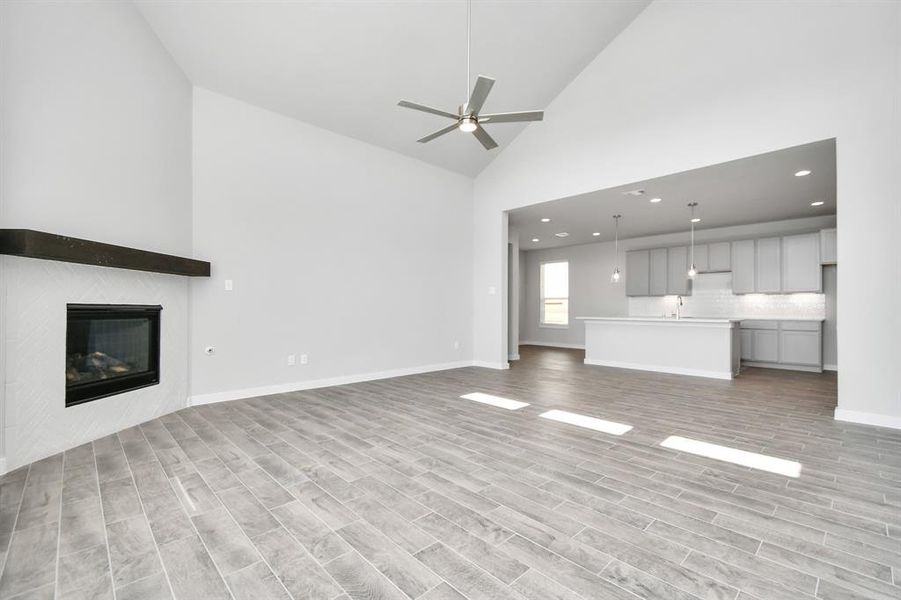 Take another glimpse into the heart of the home with this additional view of the family room—a sprawling space ready to accommodate all your gatherings. Sample photo of completed home with similar floor plan. As-built interior colors and selections may vary.