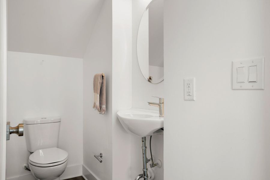 Minimalist powder room offers functional fixtures within a pristine, compact space. Minimalist powder room offers functional fixtures within a pristine, compact space.