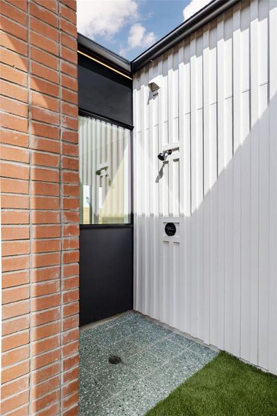 View of exterior entry featuring board and batten siding