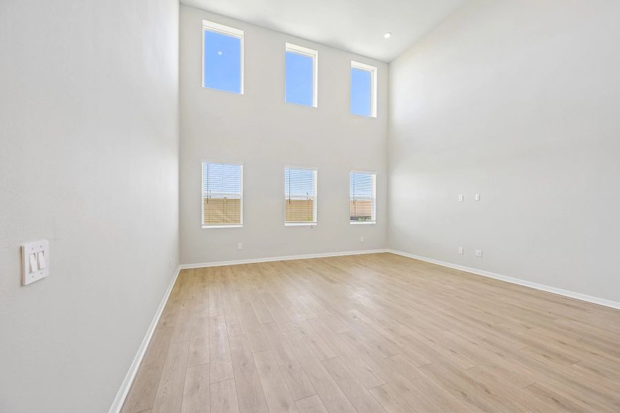 The two-story great room features six large windows creating so much natural light