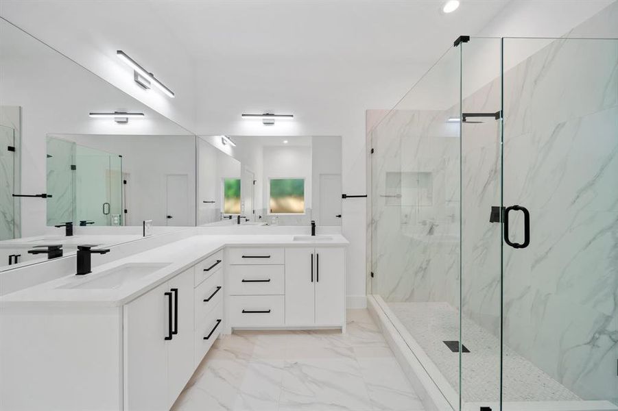 Bathroom featuring vanity and a shower with door