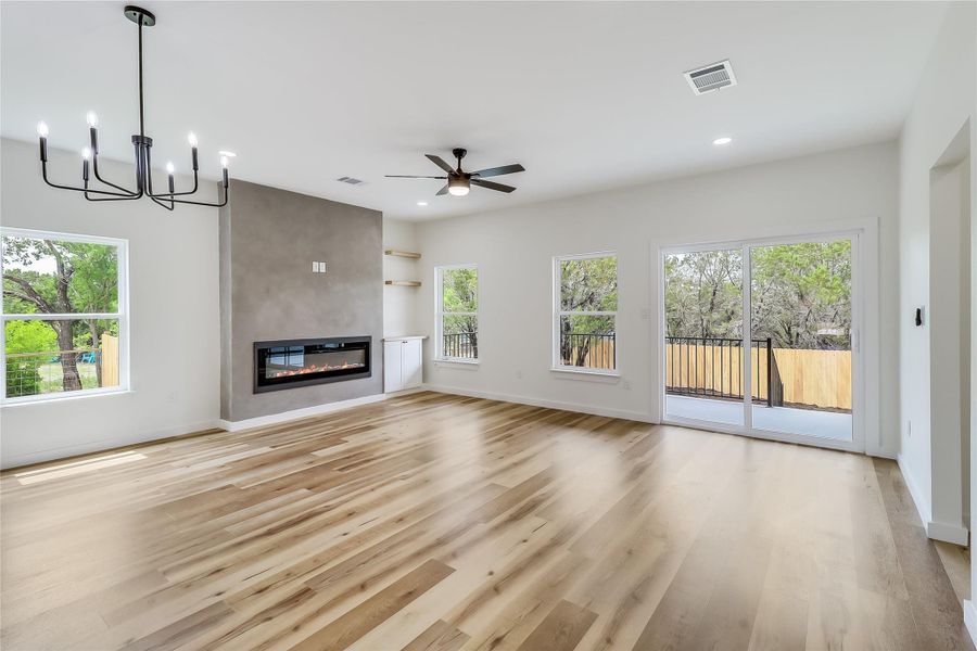 Unfurnished living room featuring a fireplace, plenty of natural light and light wood-style flooring